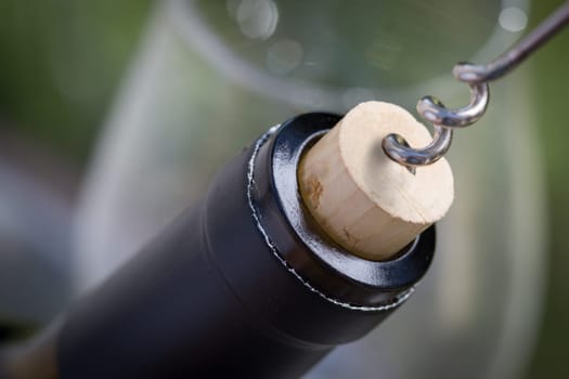 Close-up of Corkscrew Twisted Into Cork of Wine Bottle.