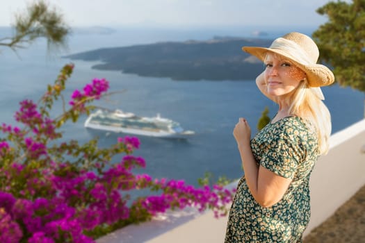 Female Tourist Off the Coast of Santorini Greece Looking Back At Camera.