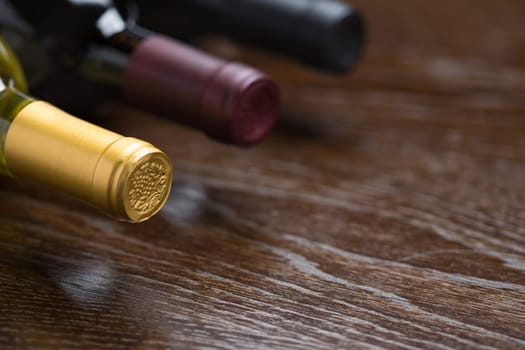 Various Wine Bottles on a Reflective Wood Surface Abstract.