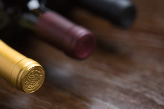 Various Wine Bottles on a Reflective Wood Surface Abstract.