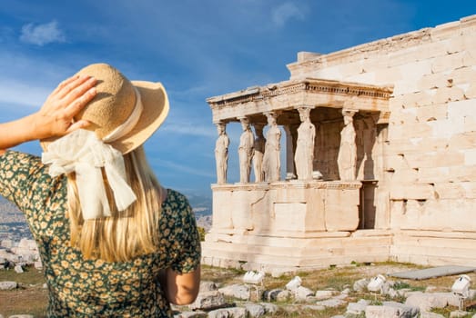Woman Gazes at The Erechtheion or Temple of Athena Polias, Acropolis, Athens, Greece..