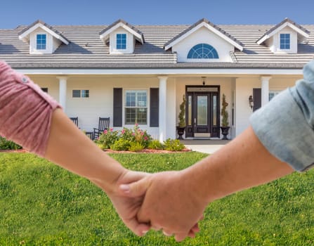Couple Holding Hands Approaching Front Door Of New House.