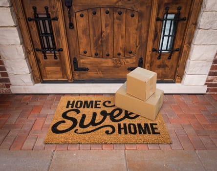 Small Packages Sitting on Home Sweet Home Welcome Mat At Front Door of House.
