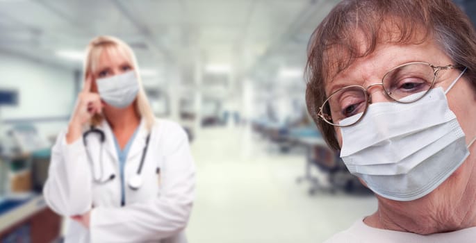 Senior Adult Female Looking Down as Doctor Stands Behind All Wearing Medical Face Masks Within Hospital.