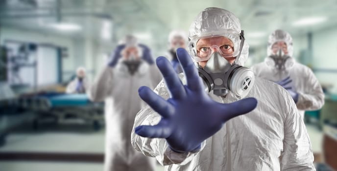 Team of Female and Male Doctors or Nurses Wearing Personal Protective Equiment In Hospital Emergency Room.