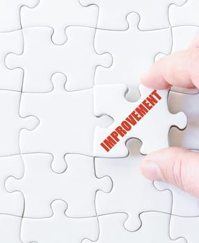 Last puzzle piece with word  IMPROVEMENT. Concept image