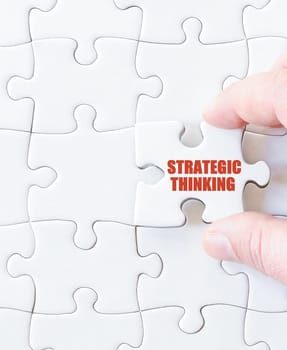 Last puzzle piece with words STRATEGIC THINKING. Concept image