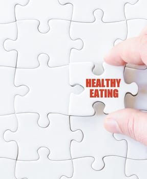 Last puzzle piece with words HEALTHY EATING. Concept image