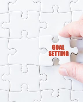 Last puzzle piece with words  GOALS SETTING. Concept image