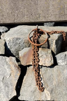 Old rusty chain to lock the boat in the harbour