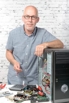 a technician repairing a computer with different tools