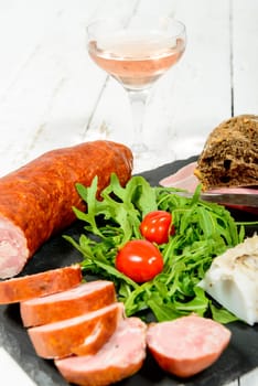 charcuterie plate with wine , bread and tomatoes