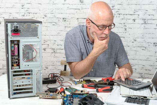 a technician repairing a computer with different tools
