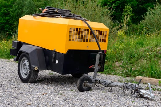 a yellow compressor site on gravel