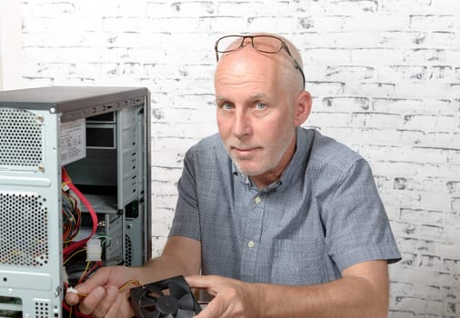 a technician repairing a computer with different tools