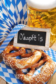 original Bavarian Laugenbrezeln with Oktoberfest beer mug and table