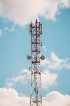 Telecommunications Cell Phone Tower With Antenna On Sunny Sky Background.