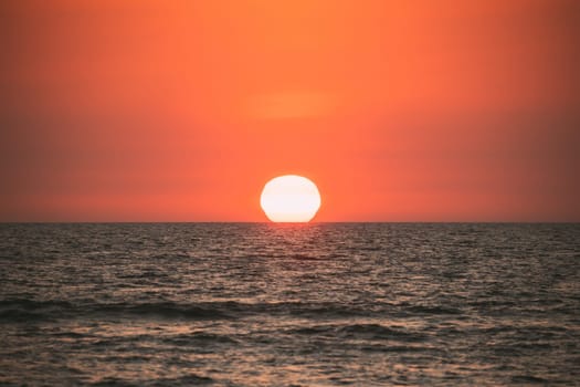 Natural Color Sunset Sunrise Sky Over Sea. Seascape With Shining Setting Sun On Sea Horizon.