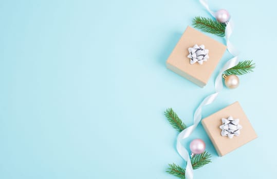 Christmas holiday greeting card with little gift boxes, stars and fir branches, blue background