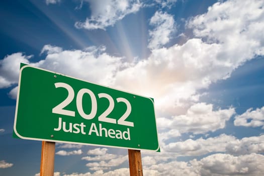 2022 Green Road Sign Over Dramatic Clouds and Sky.