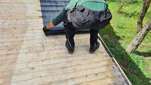 Roofing felt welding on bitumen roof roof repair with roofing felt and open flame propane tool on flat roof, leak with free space for text