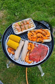 Barbecue at the campground at summer camp trips, skewers of pork and beef tenderloin at barbecue party in camping, summer camp trips an activity to relax.