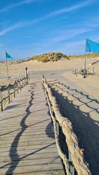 View over the sea from the dune over North Sea and canal in Ouddorp, Zeeland province, The Netherlands. Outdoor scene of coast in Europe nature.