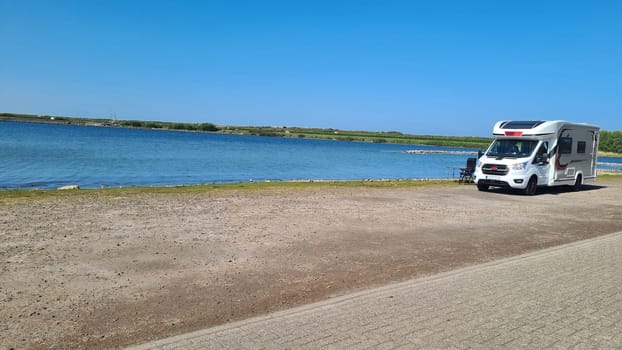 View over the sea from the dune over North Sea and canal in Ouddorp, Zeeland province, The Netherlands. Outdoor scene of coast in Europe nature.