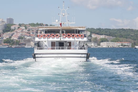 turkey istanbul 8 june 2024 Boat cruising on a sunny day in a busy harbor.