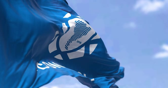 Luque, PAR, March 2022: Rear view of the a flag with the CONMEBOL logo waving in the wind. CONMEBOL stands for South American Football Confederation. Illustrative editorial