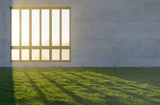 3D Illustration of Window with Bright Sun Light Shining Through Concrete Wall in Grass and Rocks Field.
