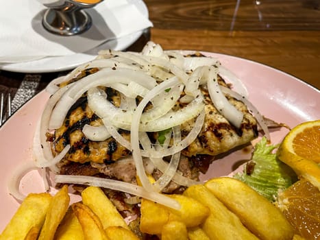 A Greek dish with a variety of meats, chips and onions.
