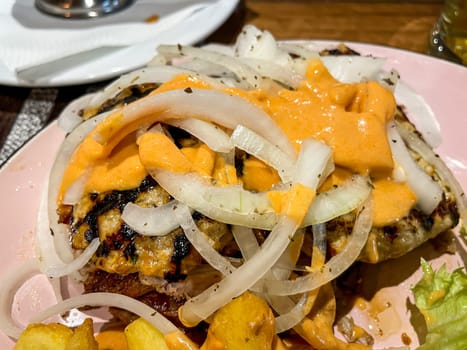 A Greek dish with a variety of meats, chips and onions.
