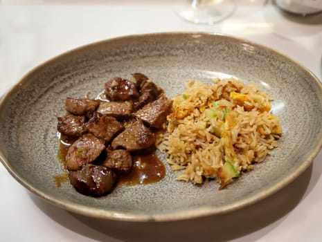Fried beef with rice on a plate at the Japanese restaurant.