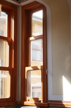 Sunlight filters through wooden-framed windows, illuminating the room.