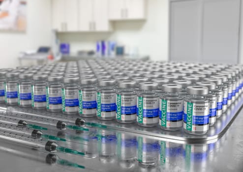 Hundreds of Coronavirus COVID-19 Vaccine Vials and Syringes In Medical Office.