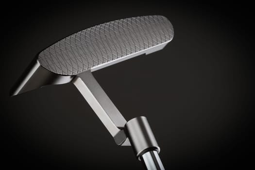 Face of Golf Club Putter On A Dark Background.