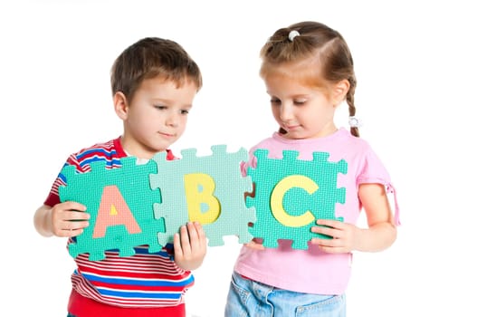boy and girl are holding colorful letters