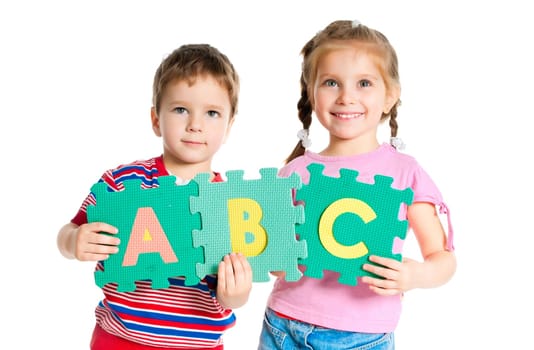 boy and girl are holding colorful letters