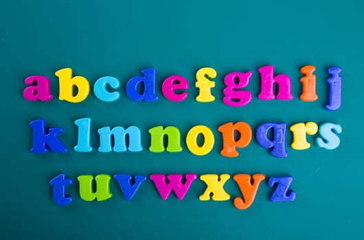 Colorful Alphabet magnetic letters on green background