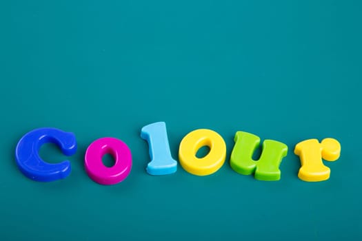 Colorful Alphabet magnetic letters on green background