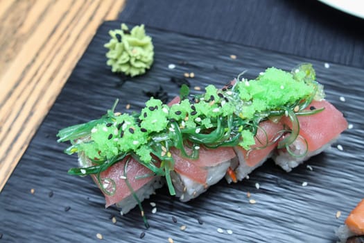 tuna sushi on ceramic black plate