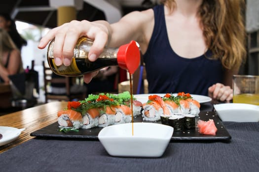 Pour soya sauce in a bowl