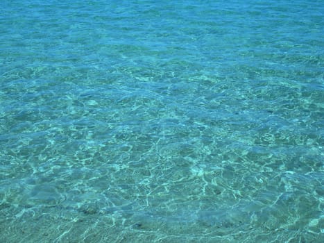 Background: Clear blue water with small waves