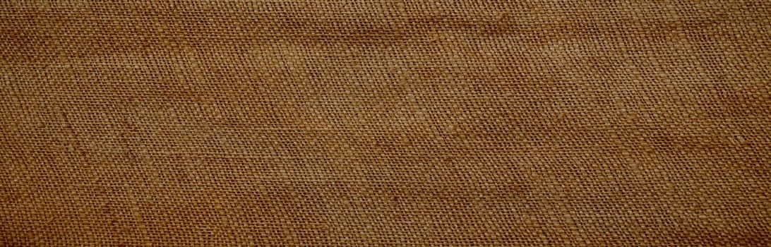 Background of an old brown jutesack in panorama format