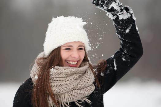 Young woman enjoys the snow
