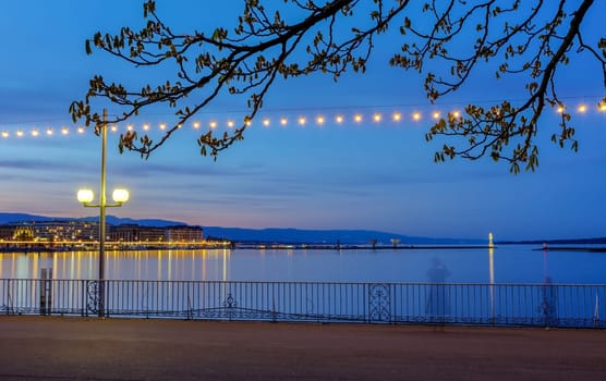 Bench at the english garden promenade near the lake by night, Geneva, Switzerland, HDR