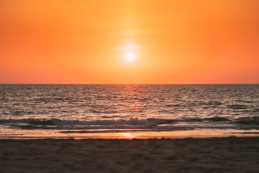 Natural Color Sunset Sunrise Sky Over Sea. Seascape With Shining Setting Sun On Sea Horizon.