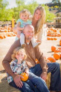 Adorable Young Family Enjoys a Day at the Pumpkin Patch.