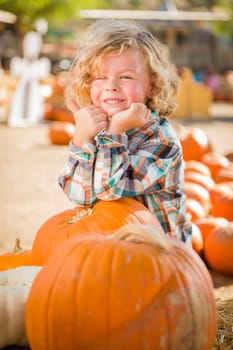 Little Boy Standing in a Rustic Ranch Setting at the Pumpkin Patch.